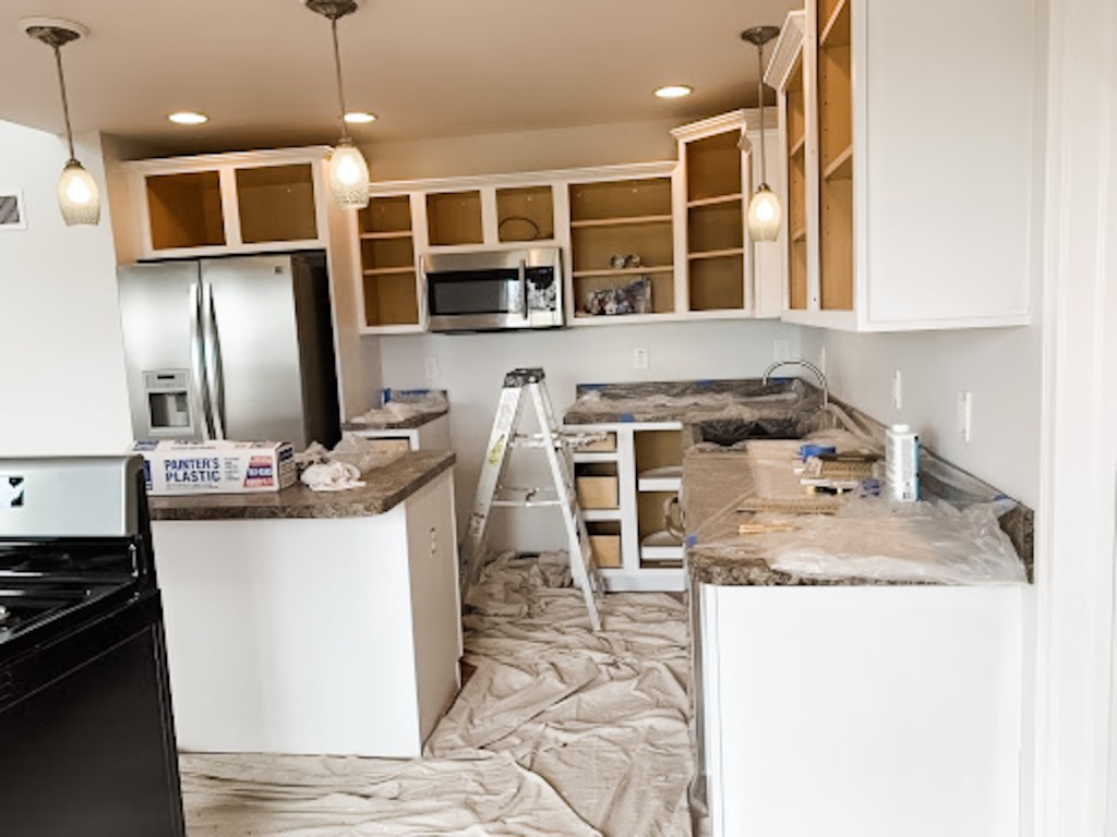 painting kitchen cabinets in progress