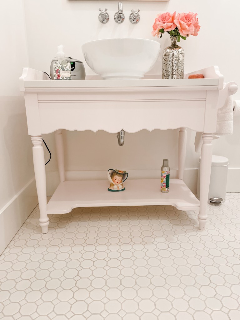 pink bathroom vanity with penny tile