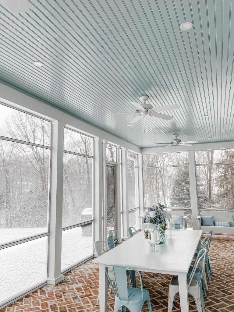 screened in porch with white ceiling fan and recessed lights