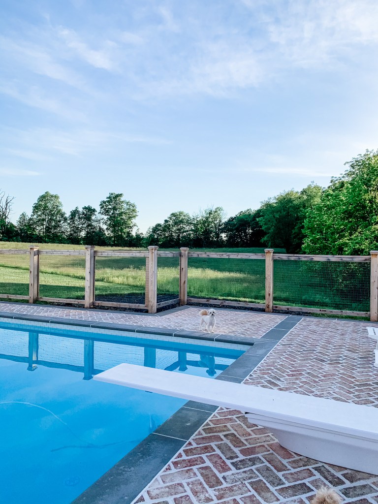 in-ground pool with a diving board