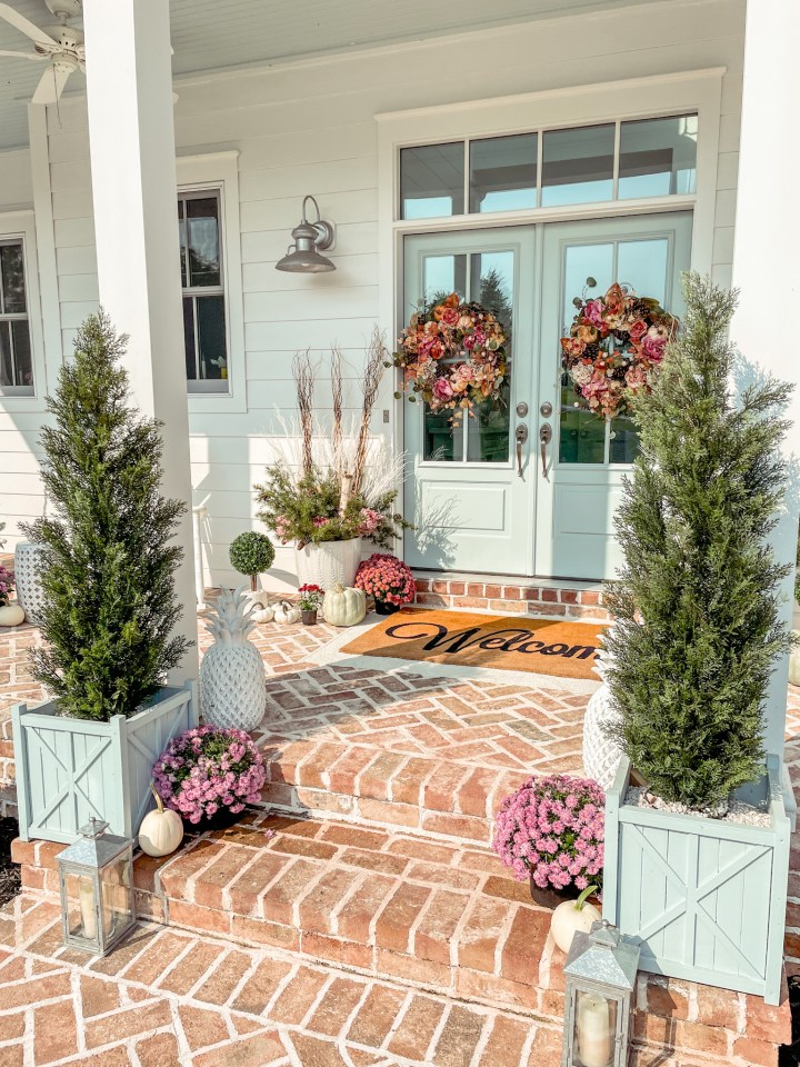 fall front porch with a blue front door