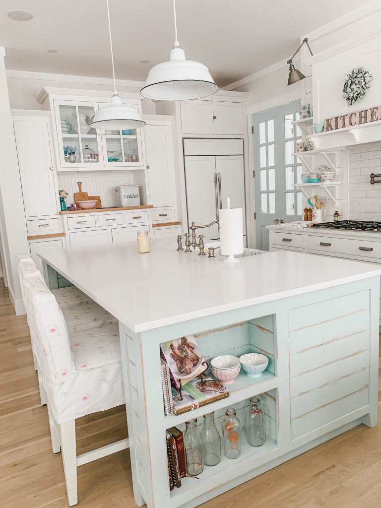 blue kitchen island with white cabinetry